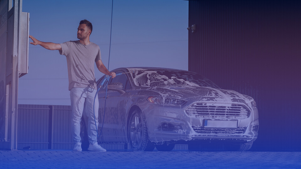 Man next to his clean car at Falcon Carwash