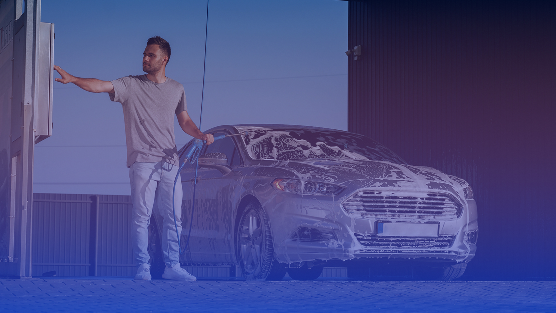 Man next to his clean car at Falcon Carwash